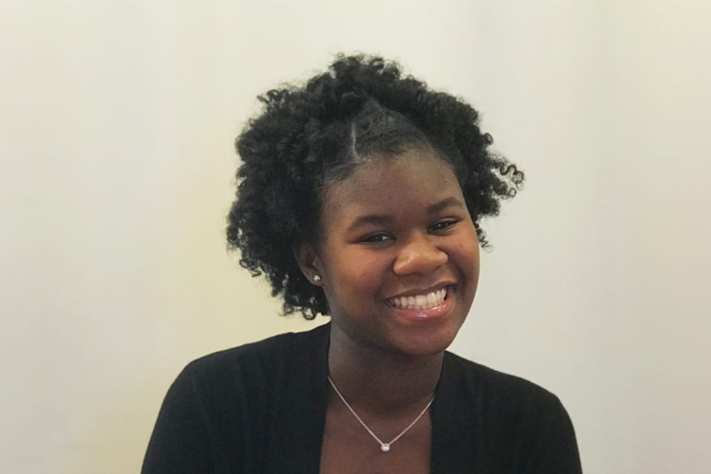 A portrait of McKenzie Strong, Applied Development's Baltimore YouthWorks Hire One Youth Intern.