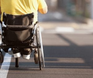boy in wheelchair on road