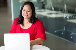 women business owner typing on her computer