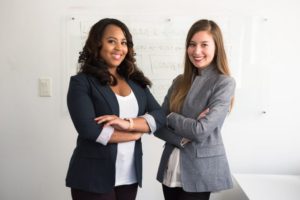 two woman business owners standing side by side