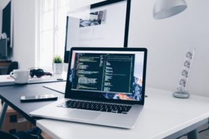 computer sitting on desk with code on it for making it more accessible