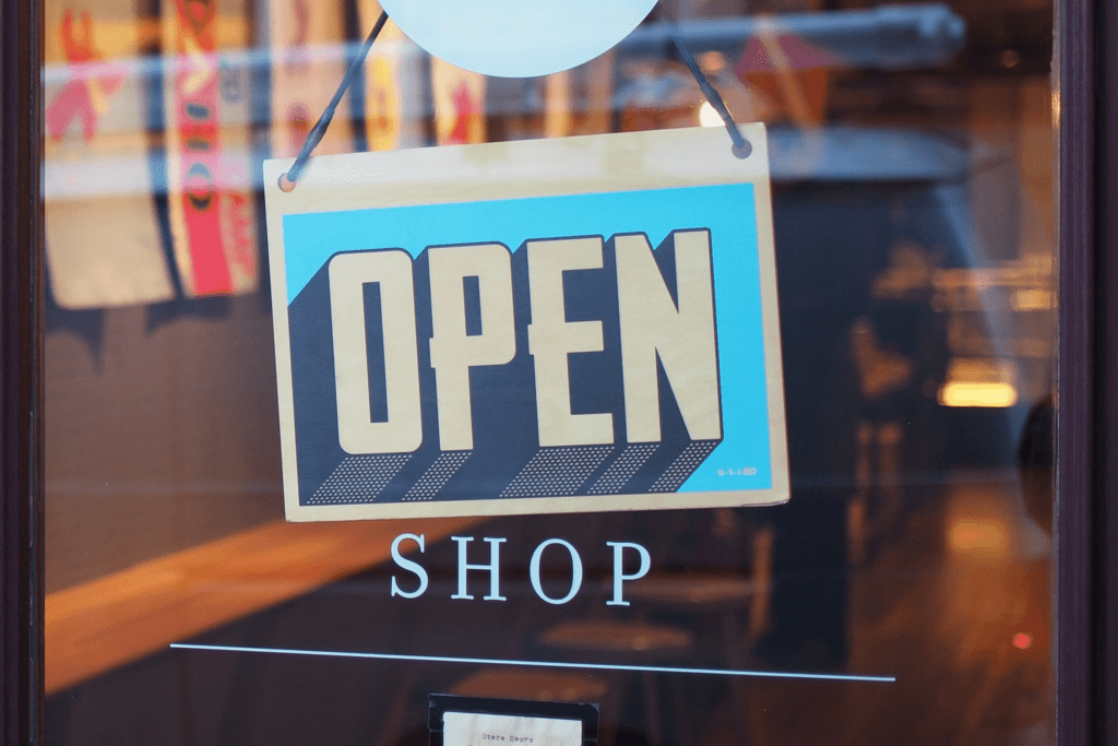 open sign in window of small business