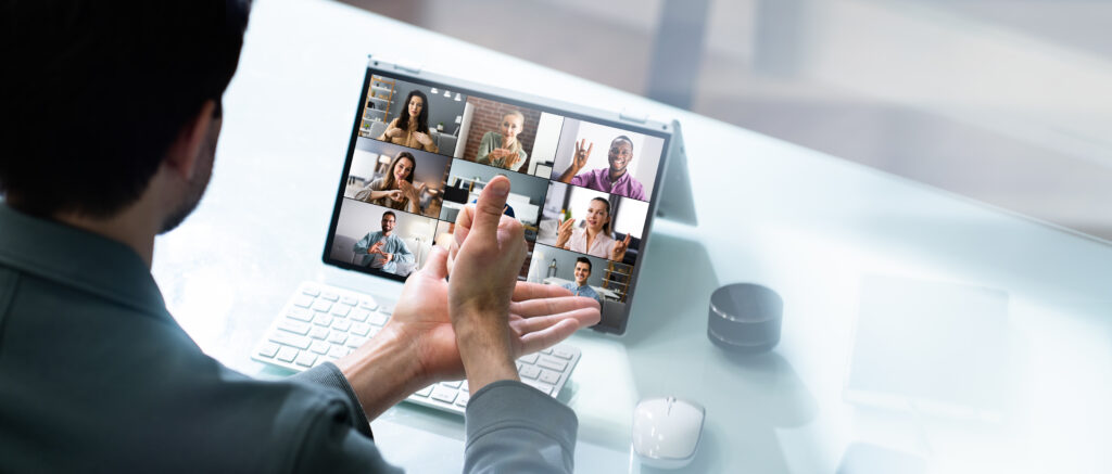 Person using sign language in online video call, displaying communication tools for the hearing impaired.