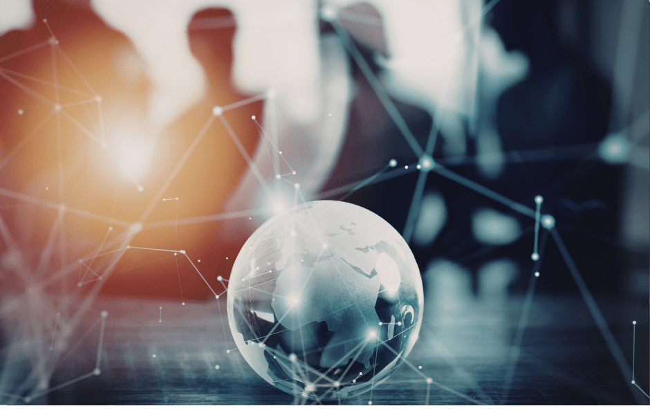 Globe on table with abstract network lines, blurred people in background, symbolizing global connectivity.